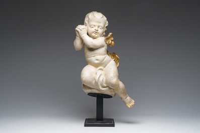 A Flemish patinated and gilt wooden angel mounted on a pedestal, 18th C.