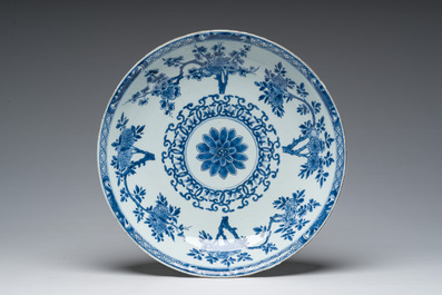 A Chinese blue and white dish and three famille rose plates with floral design, Kangxi/Qianlong