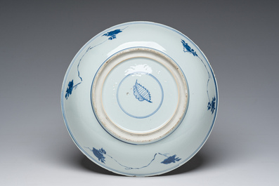 A Chinese blue and white dish and three famille rose plates with floral design, Kangxi/Qianlong