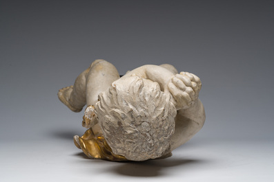 A Flemish patinated and gilt wooden angel mounted on a pedestal, 18th C.