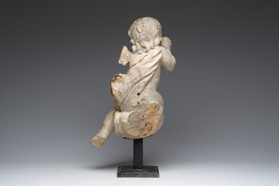 A Flemish patinated and gilt wooden angel mounted on a pedestal, 18th C.