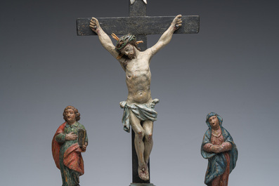 A Spanish polychrome decorated wooden crucifixion group with Jesus on the cross flanked by Mary and John the Evangelist, 18th C.