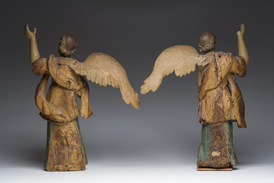A pair of Italian gilt and polychrome decorated wooden angels, late 18th C.