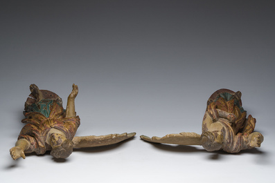 A pair of Italian gilt and polychrome decorated wooden angels, late 18th C.