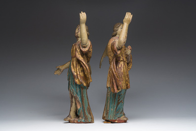 A pair of Italian gilt and polychrome decorated wooden angels, late 18th C.