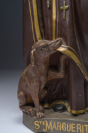 A polychrome decorated plaster figure of Saint Margaret with her dog, 19th/20th C.