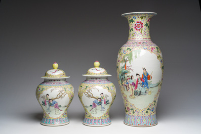 A Chinese famille rose yellow-ground baluster vase and a pair of vases and covers with animated scenes, Qianlong marks, Republic, 20th C.