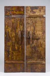 Two black lacquered and polychrome decorated wooden doors with boys holding a vase and a censer, Tibet, 19th C.