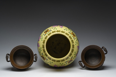 A Sarreguemines yellow-ground Art Nouveau vase with floral design and a pair of patinated bronze urns with 'nymphs' relief design, 20th C.