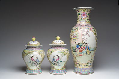 A Chinese famille rose yellow-ground baluster vase and a pair of vases and covers with animated scenes, Qianlong marks, Republic, 20th C.