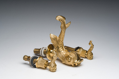 An Italian gilt bronze dolphin-shaped tap and two associated tap buckles, 20th C.
