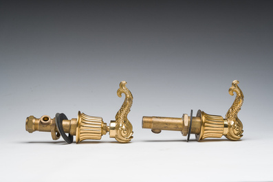 An Italian gilt bronze dolphin-shaped tap and two associated tap buckles, 20th C.
