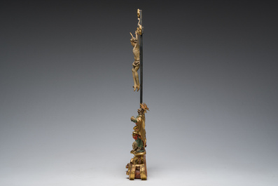 An Italian gilt and polychrome decorated wooden crucifixion group with Jesus on the cross flanked by Mary and John the Evangelist, 18th C.