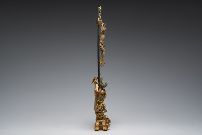 An Italian gilt and polychrome decorated wooden crucifixion group with Jesus on the cross flanked by Mary and John the Evangelist, 18th C.
