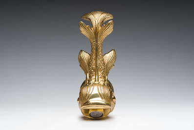 An Italian gilt bronze dolphin-shaped tap and two associated tap buckles, 20th C.
