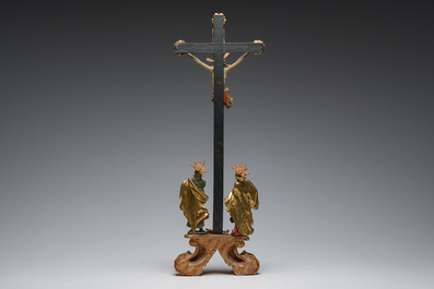 An Italian gilt and polychrome decorated wooden crucifixion group with Jesus on the cross flanked by Mary and John the Evangelist, 18th C.