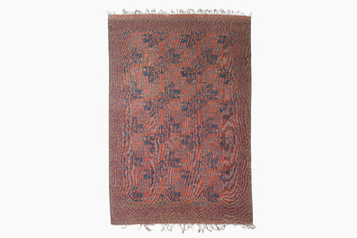 An Afghan rug with geometric design, wool on cotton, 20th C.