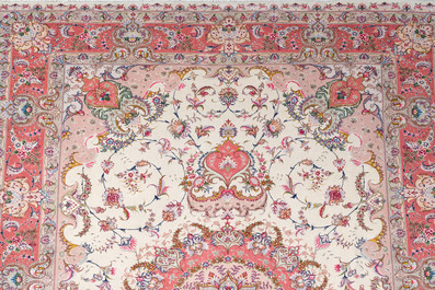A Chinese Tabriz style rug with floral design, wool on silk, 20th C.