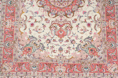 A Chinese Tabriz style rug with floral design, wool on silk, 20th C.