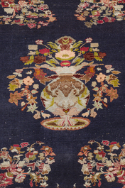 A Persian Isfahan rug and a Turkmen rug with floral design, wool, cotton and silk, 20th C.