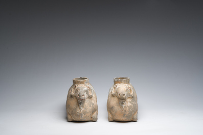 A pair of Chinese polychrome painted pottery ram-shaped vessels, Han dynasty