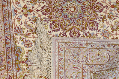 A Persian Isfahan rug and a Turkmen rug with floral design, wool, cotton and silk, 20th C.