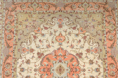 A Persian Tabriz rug with floral design, wool, cotton and silk, 20th C.