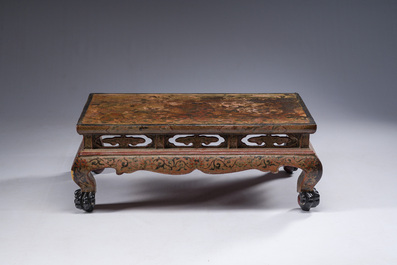 A Chinese rectangular carved and lacquered wooden low table with peach design, Qing
