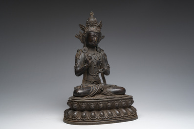 A Sino-Tibetan patinated bronze figure of Buddha, 20th C.