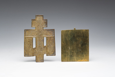 Two Russian orthodox partly enamelled bronze travel icons and an icon cross, 19th/20th C.