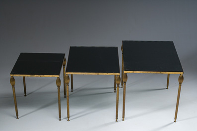Three French Maison Jansen style brass nesting tables with fluted legs and mirrored glass tops, 1960s