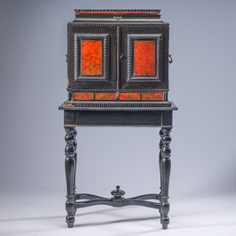 An ebonized wooden and tortoiseshell-veneered Antwerp cabinet on stand, 17th C. and later