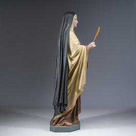 A large polychrome decorated plaster figure of Saint Teresa of Avila with glass eyes, 19th/20th C.