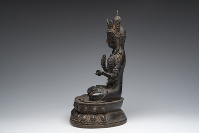 A Sino-Tibetan patinated bronze figure of Buddha, 20th C.