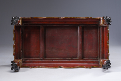 A Chinese rectangular carved and lacquered wooden low table with peach design, Qing