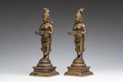 A pair of Indian oil lamps in the shape of Deepalakshmi with a bowl in her hands, 20th C.