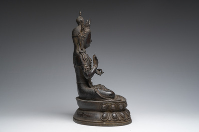 A Sino-Tibetan patinated bronze figure of Buddha, 20th C.
