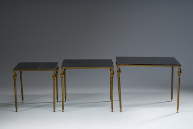 Three French Maison Jansen style brass nesting tables with fluted legs and mirrored glass tops, 1960s