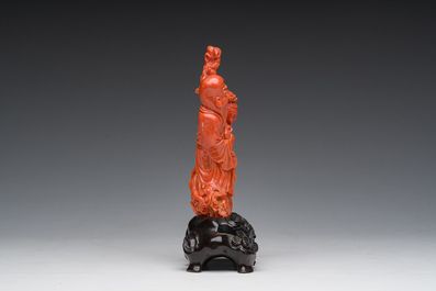 A Chinese red coral group with the 'Star God' Shou Xing and a lady, 19th/20th C.