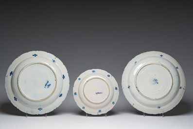 Three Dutch Delft blue and white dishes with a bird and floral design and two pharmacy jars, 18th C.