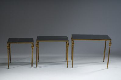 Three French Maison Jansen style brass nesting tables with fluted legs and mirrored glass tops, 1960s