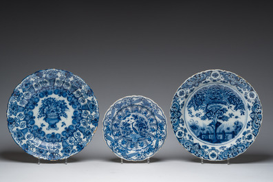 Three Dutch Delft blue and white dishes with a bird and floral design and two pharmacy jars, 18th C.