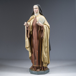 A large polychrome decorated plaster figure of Saint Teresa of Avila with glass eyes, 19th/20th C.
