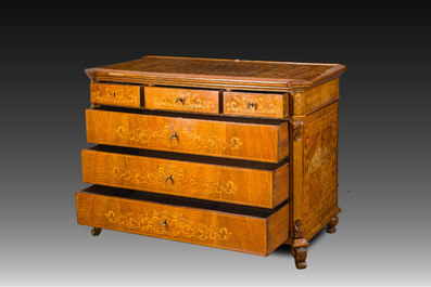 A North Italian commode with four drawers in mahogany and walnut with inlay of sphinxes and flowers in lemonwood, first third 19th C.