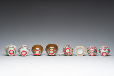Six Chinese famille rose and gilt cups and saucers and a cream jug with floral and mandarin design, Yongzheng/Qianlong