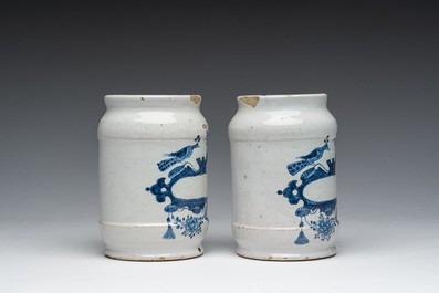 Three Dutch Delft blue and white dishes with a bird and floral design and two pharmacy jars, 18th C.