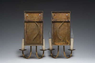 A pair of two-light wall lights in the shape of winged caryatids in patinated cast iron and brass, 20th C.