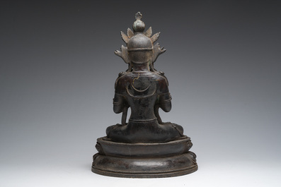 A Sino-Tibetan patinated bronze figure of Buddha, 20th C.