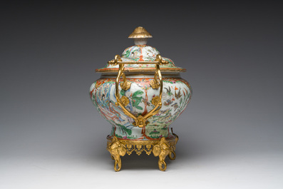 A Chinese Canton famille rose gilt mounted tureen and cover with animated scenes resting on four elephant heads, 19th C.