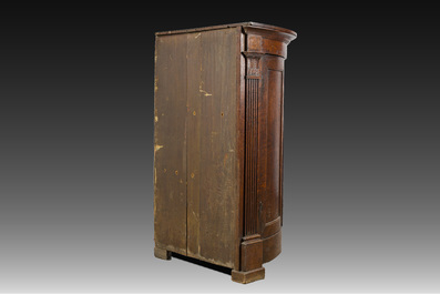 A Flemish Empire style carved oak two-door corner cupboard, 19th C.